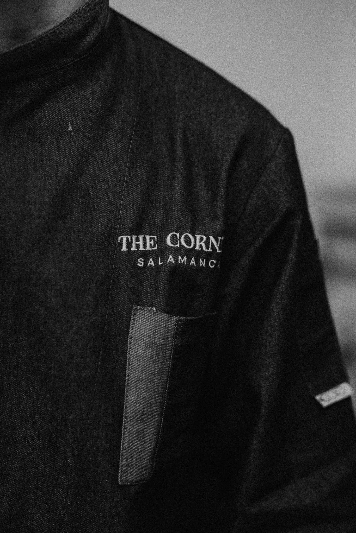 The Corner Salamanca embroidered on a dark staff uniform.